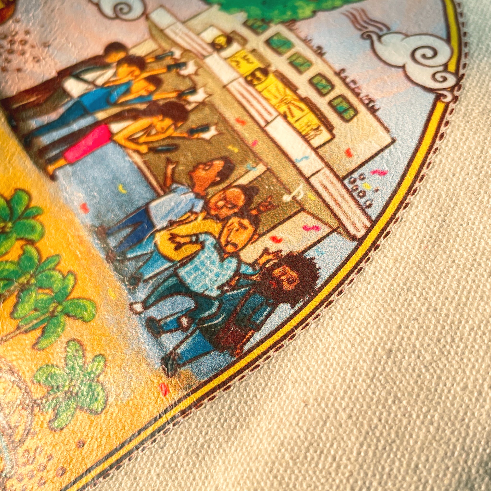 Close-up of a tarot card with colorful illustrations of people and buildings.